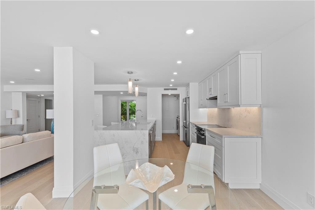 Dining space with light wood-style flooring and recessed lighting