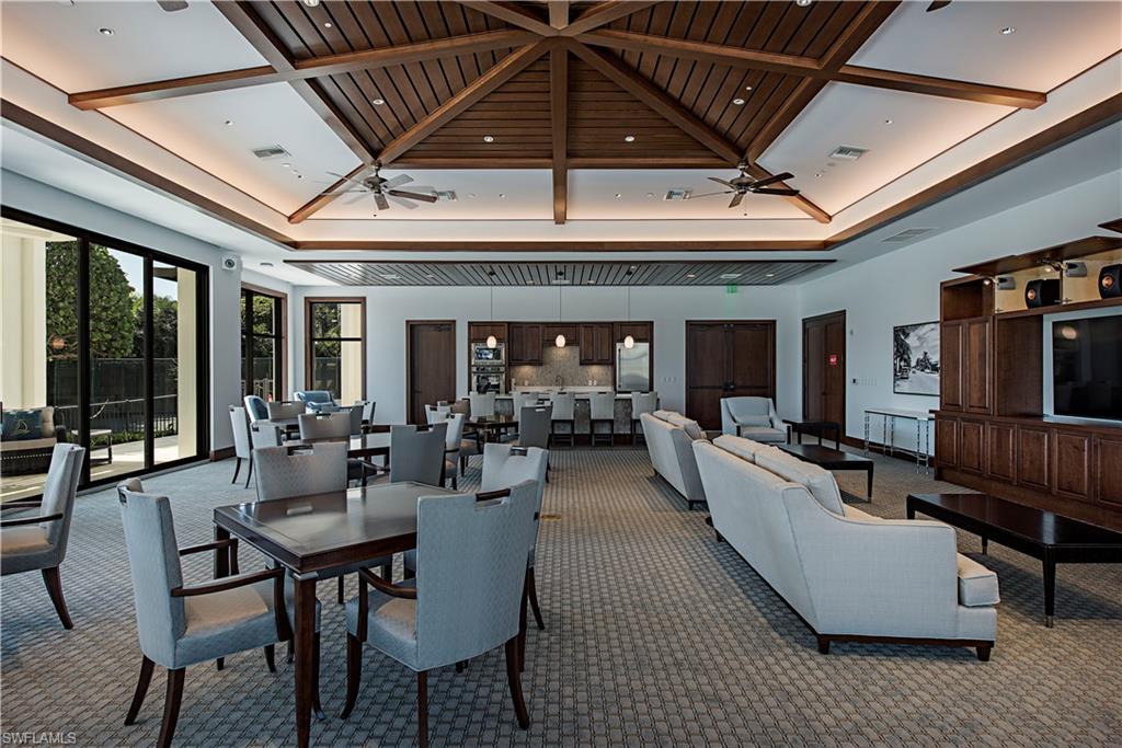 Common area with coffered ceiling and a high ceiling