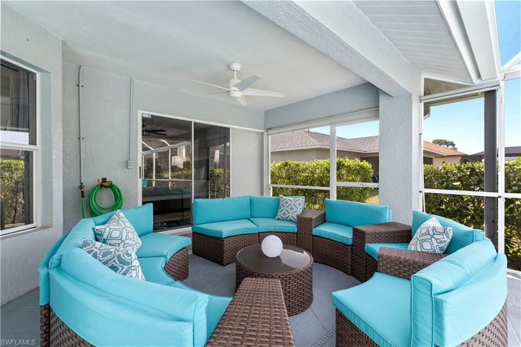 Covered seating area on lanai by pool.