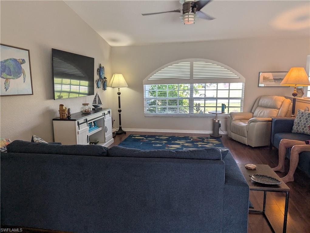 Living area featuring wood finished floors and a ceiling fan