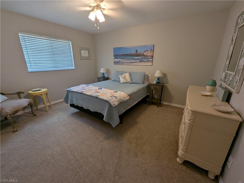 Bedroom featuring light carpet and a ceiling fan