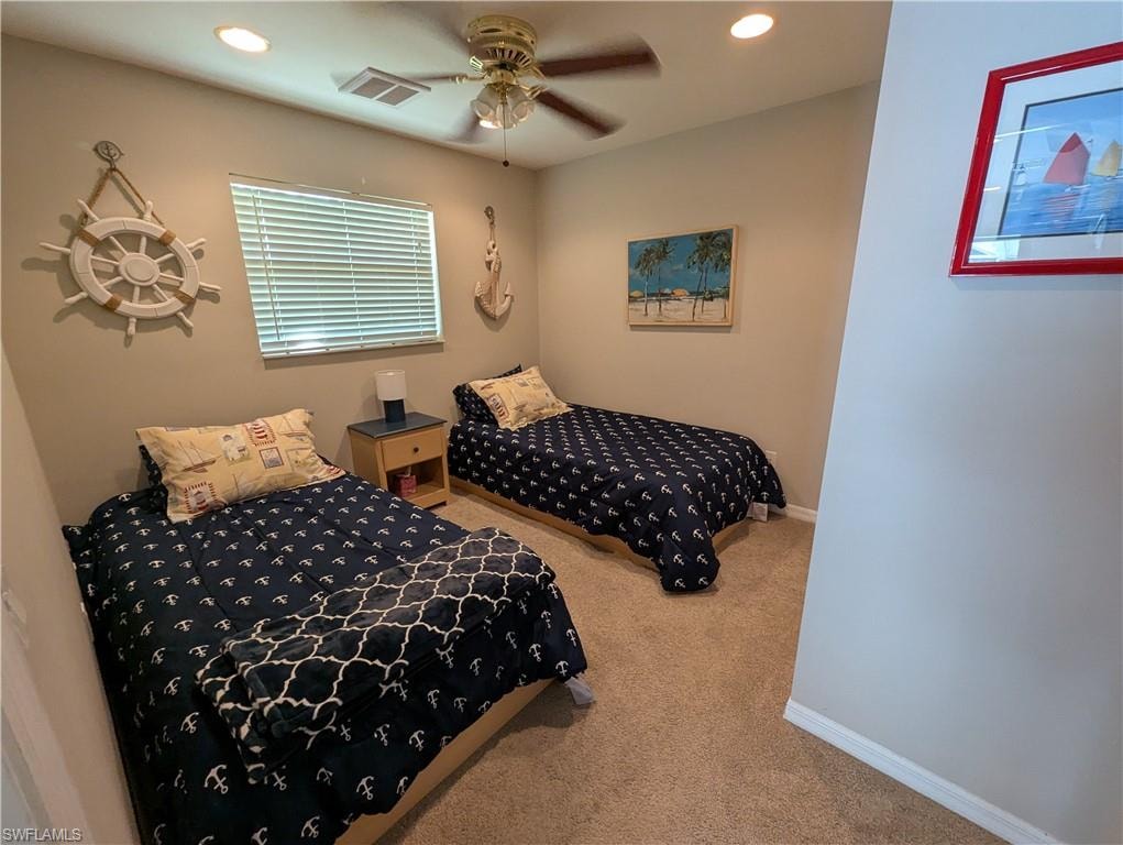 Carpeted bedroom featuring recessed lighting and a ceiling fan