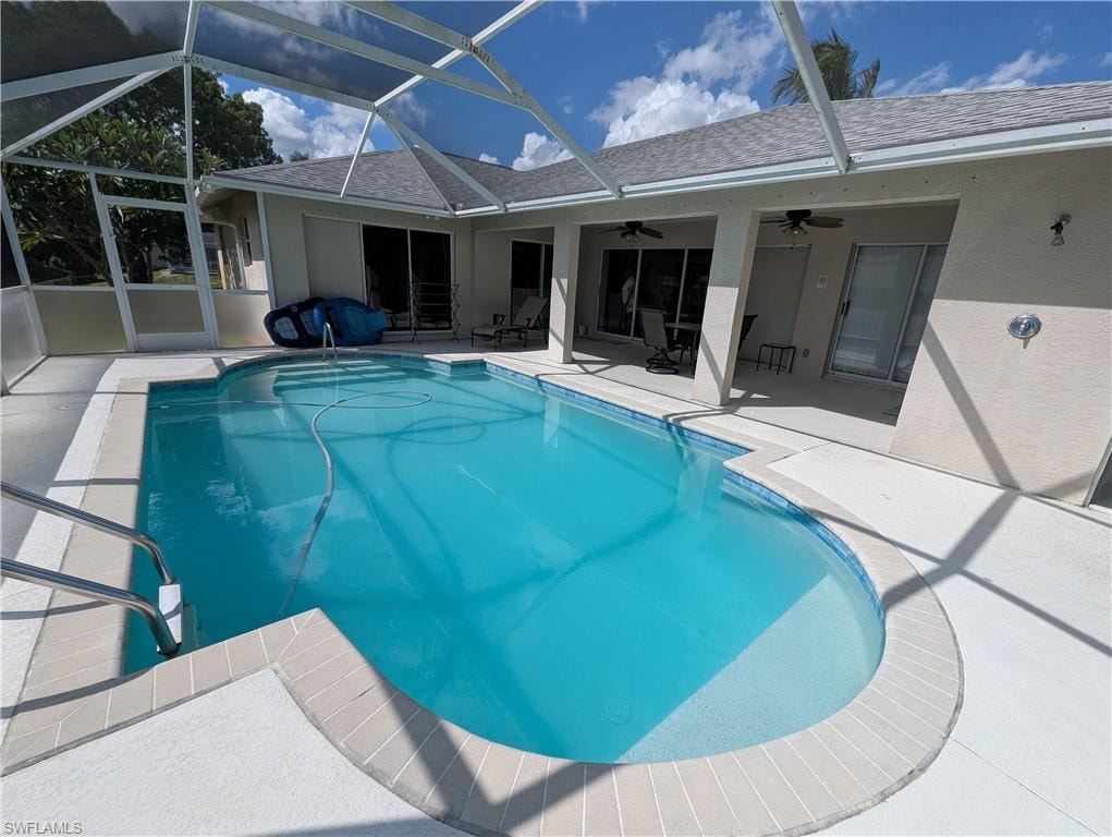 Swimming pool featuring a patio, a lanai, a sunroom, and ceiling fan