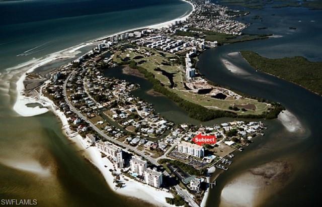Aerial view of property and surrounding area with expansive beach