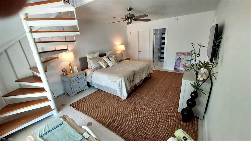 Bedroom with tile patterned floors and a ceiling fan