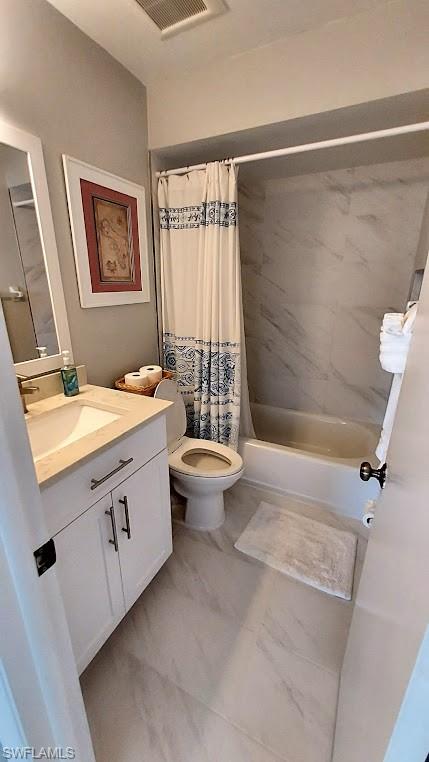 Full bath with shower / bath combo with shower curtain and vanity