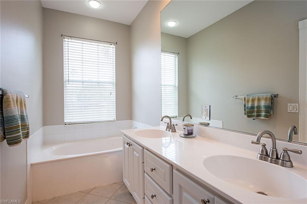 Master Bathroom featuring double vanity, soaking tub and separate shower