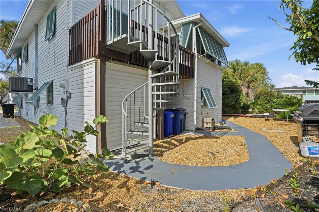 Rear view of property with stairway and a balcony - Virtually Edited Image