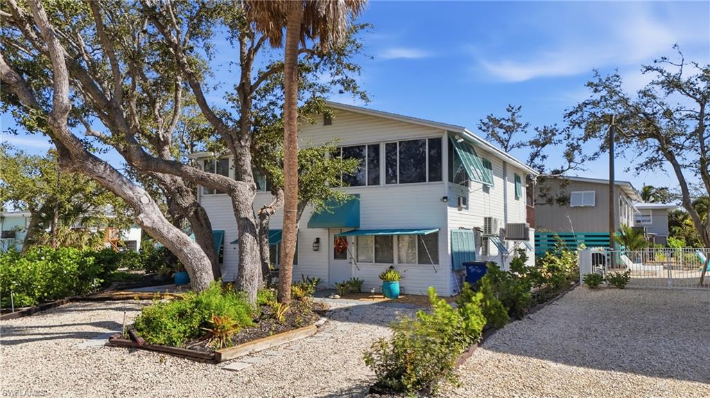 View of front of home featuring a sunroom - Virtually Edited Image