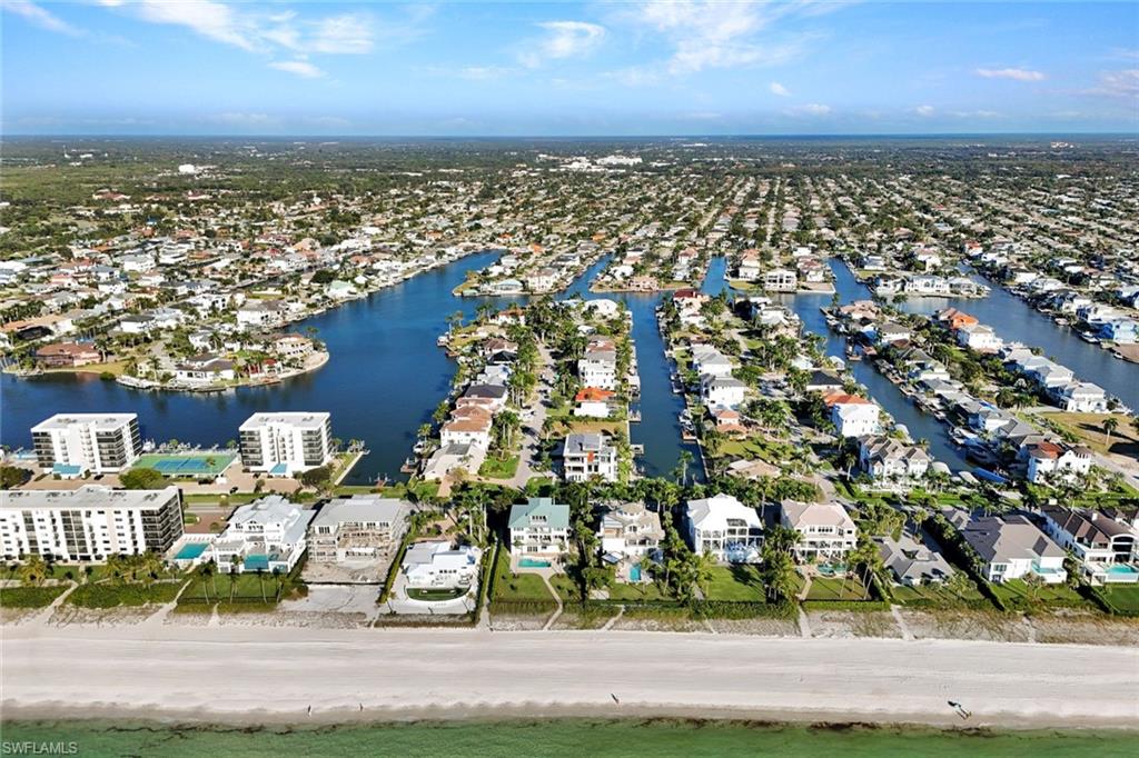 Aerial view of residential area featuring a nearby body of water