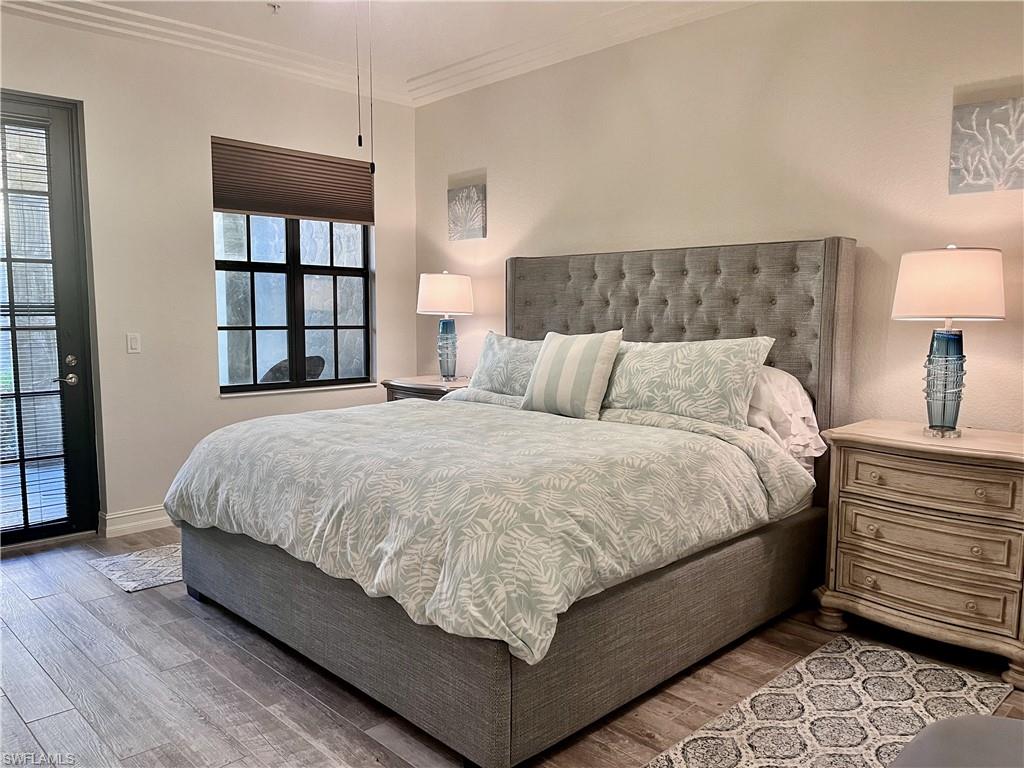 Bedroom with crown molding and wood-type flooring