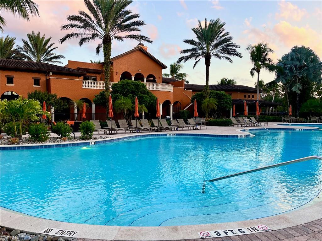 Pool at dusk featuring a patio area
