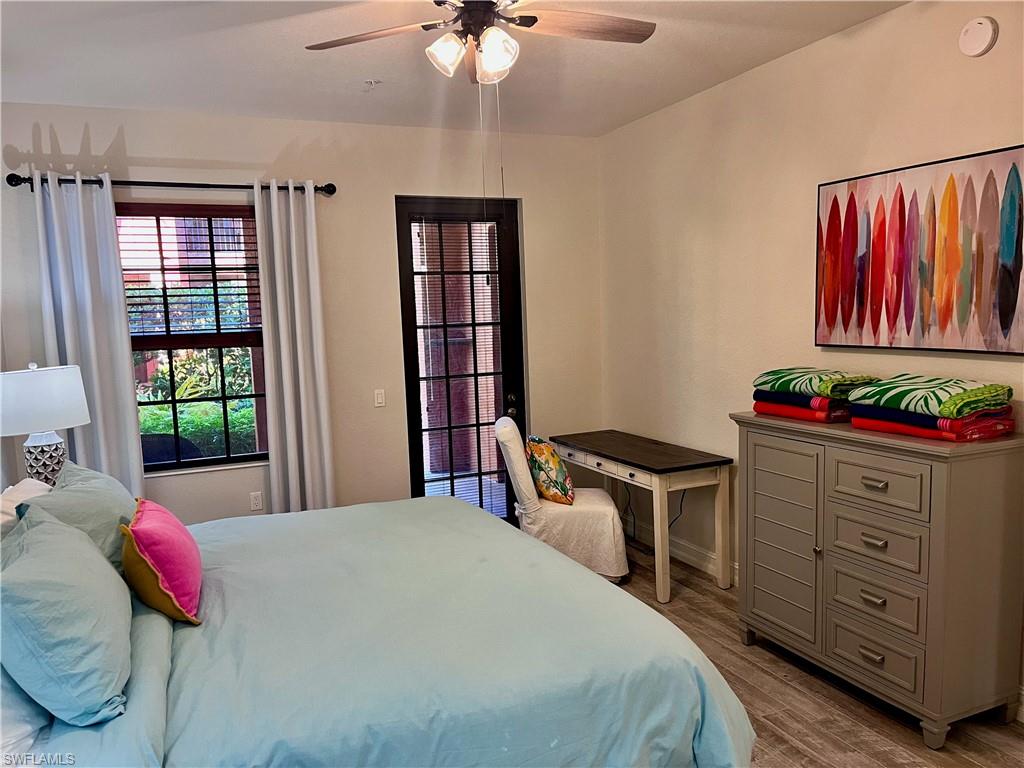 Bedroom featuring ceiling fan and desk area with dresser.