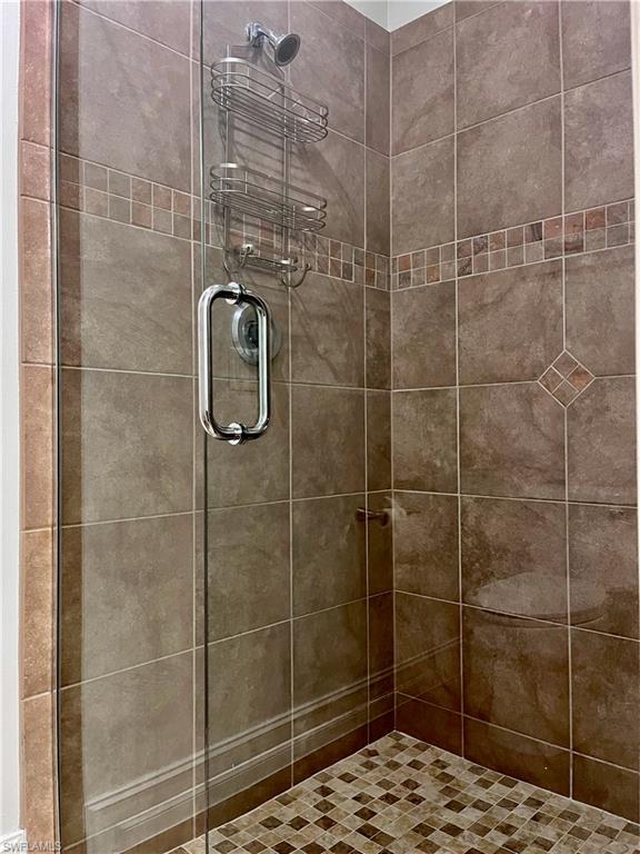 Bathroom with a stall shower, brand new door and toilet area with a pocket door