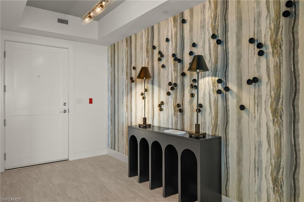 Foyer has contemporary design using black, silver and gold metals