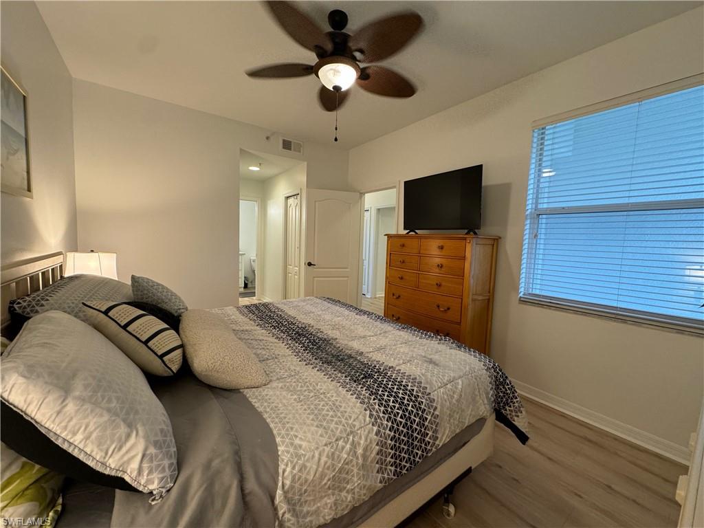 Bedroom featuring light wood-type flooring, ceiling fan, and a closet