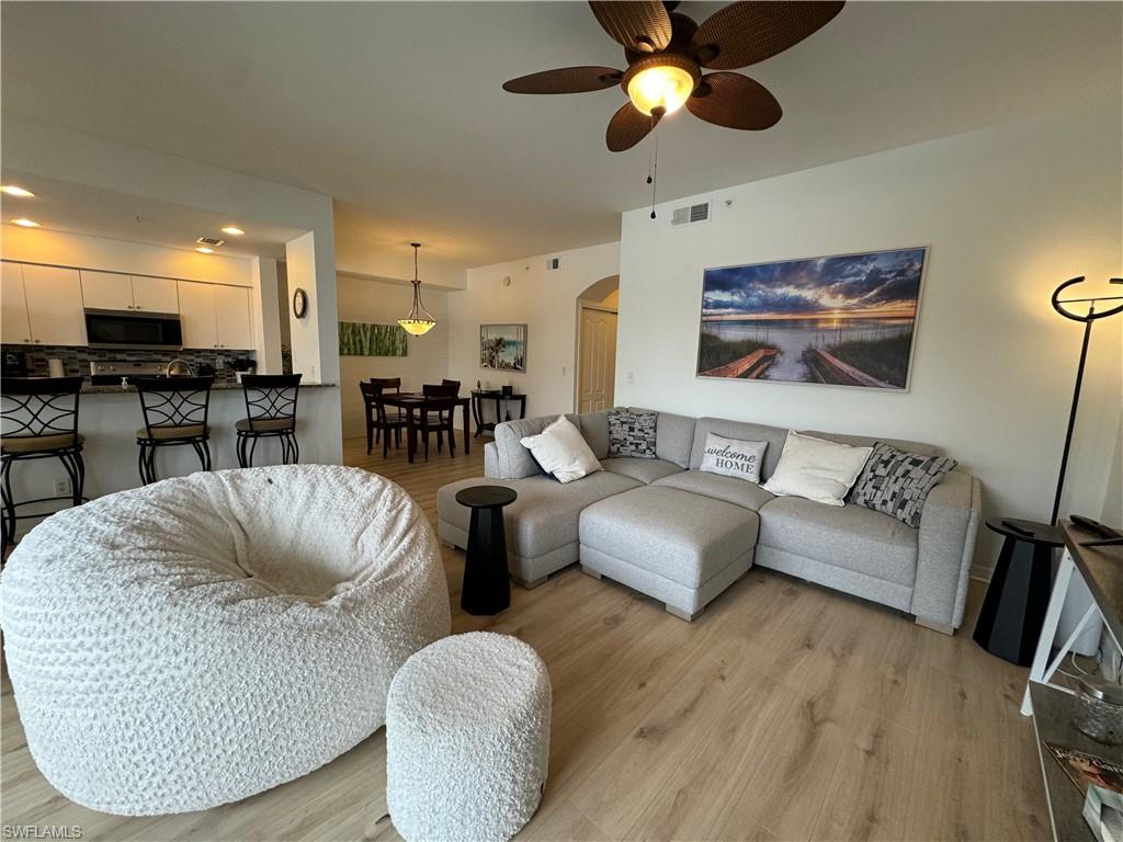 Living room featuring light hardwood / wood-style floors and ceiling fan