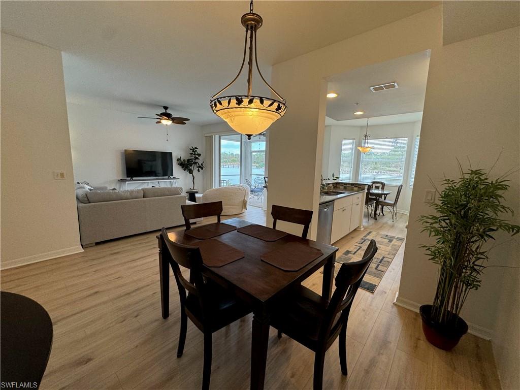Dining space featuring a wealth of natural light, ceiling fan, sink, and light hardwood / wood-style floors