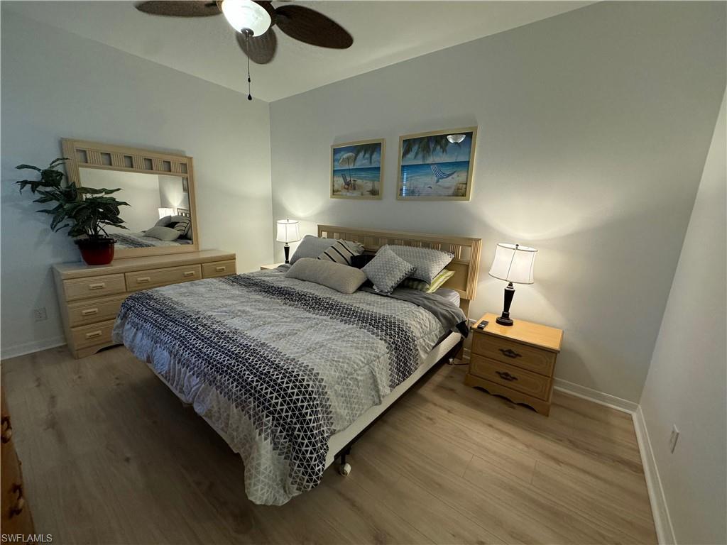 Bedroom featuring light hardwood / wood-style floors and ceiling fan