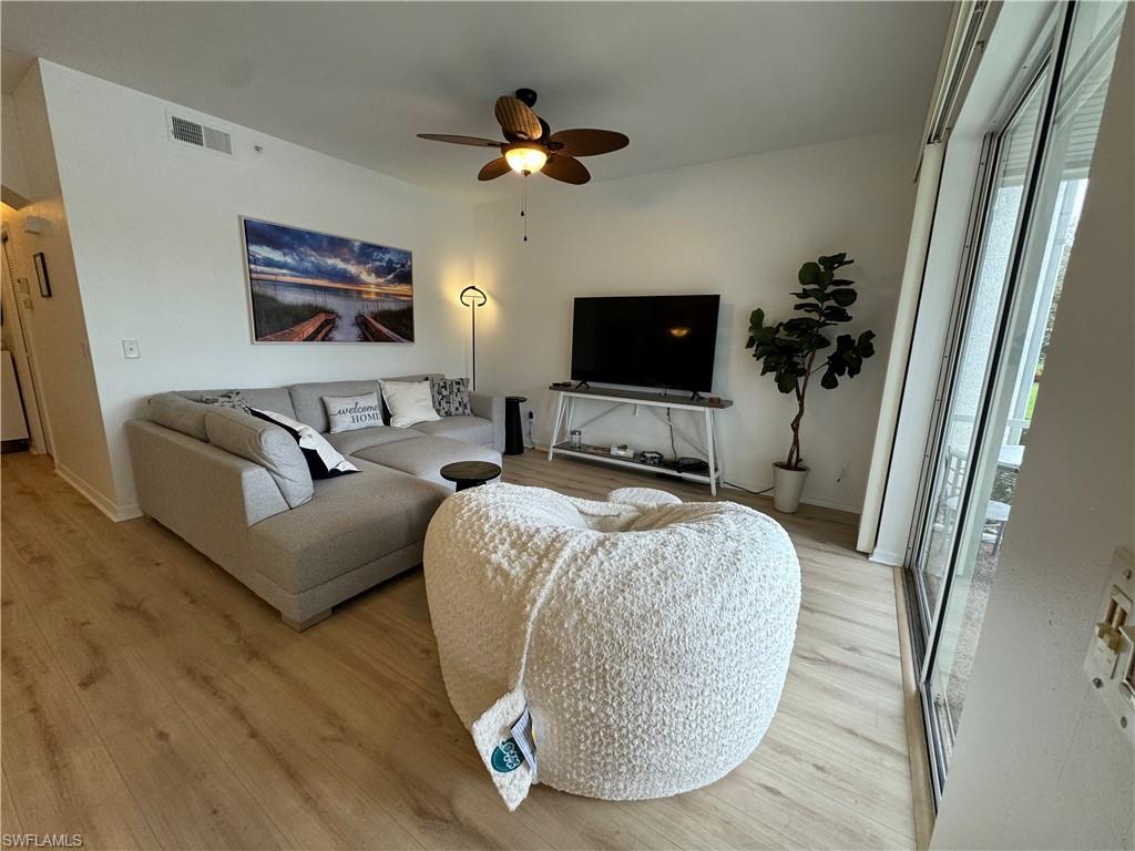 Living room featuring light hardwood / wood-style flooring and ceiling fan