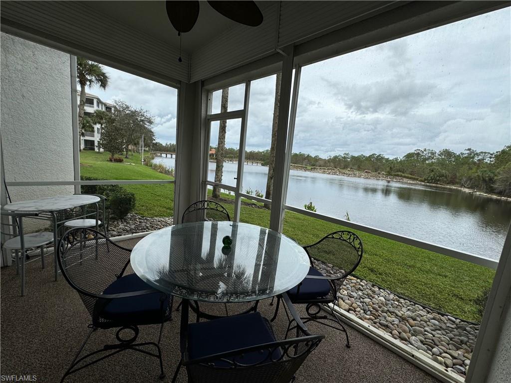Sunroom with a water view and ceiling fan