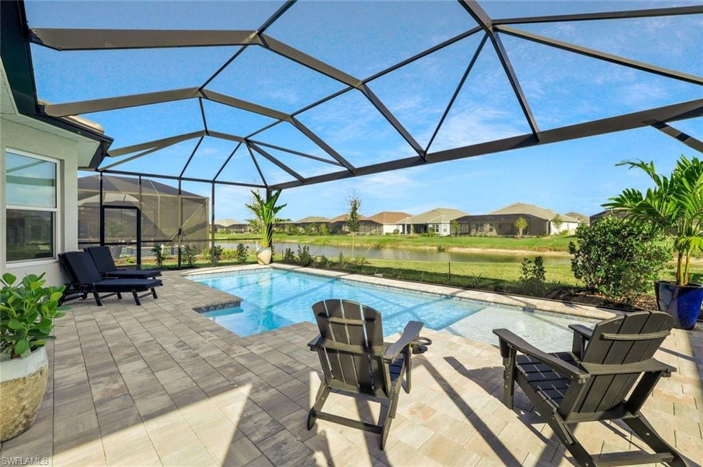 Outdoor pool featuring a water view, a sunroom, a patio, a residential view, and a lanai