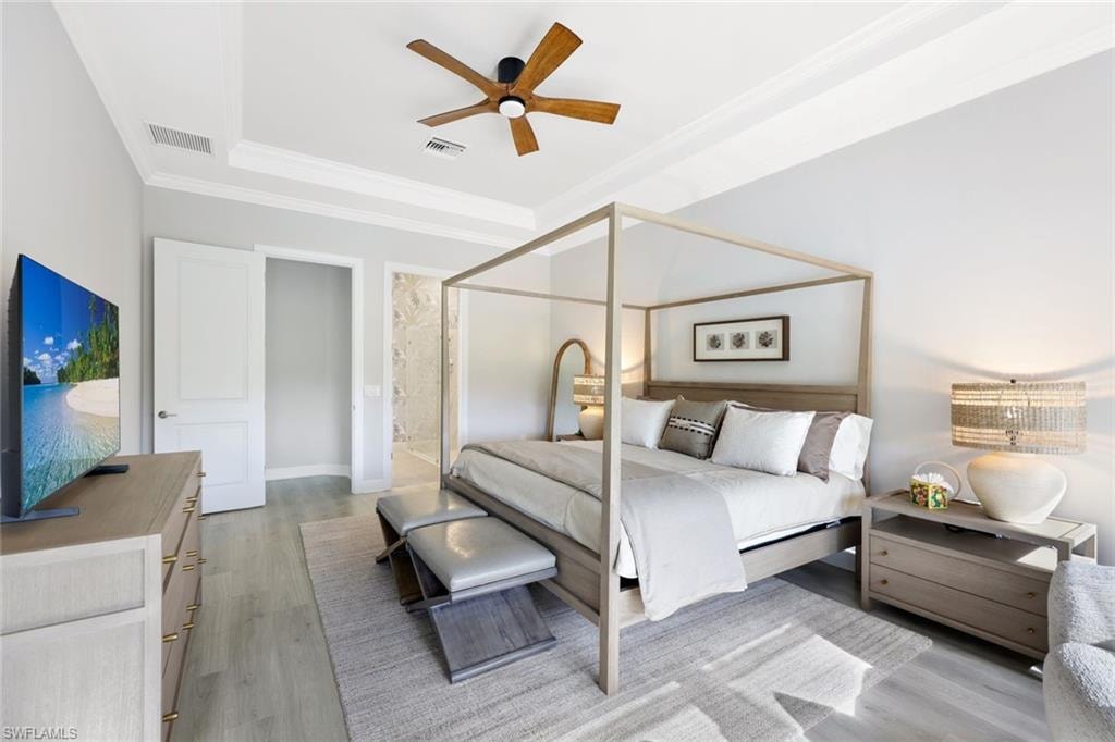Living area featuring light wood-style floors and crown molding