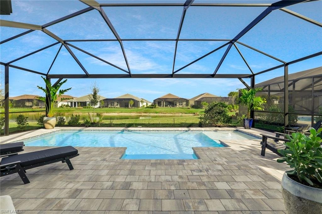 Outdoor pool with a sunroom, a lanai, and a patio