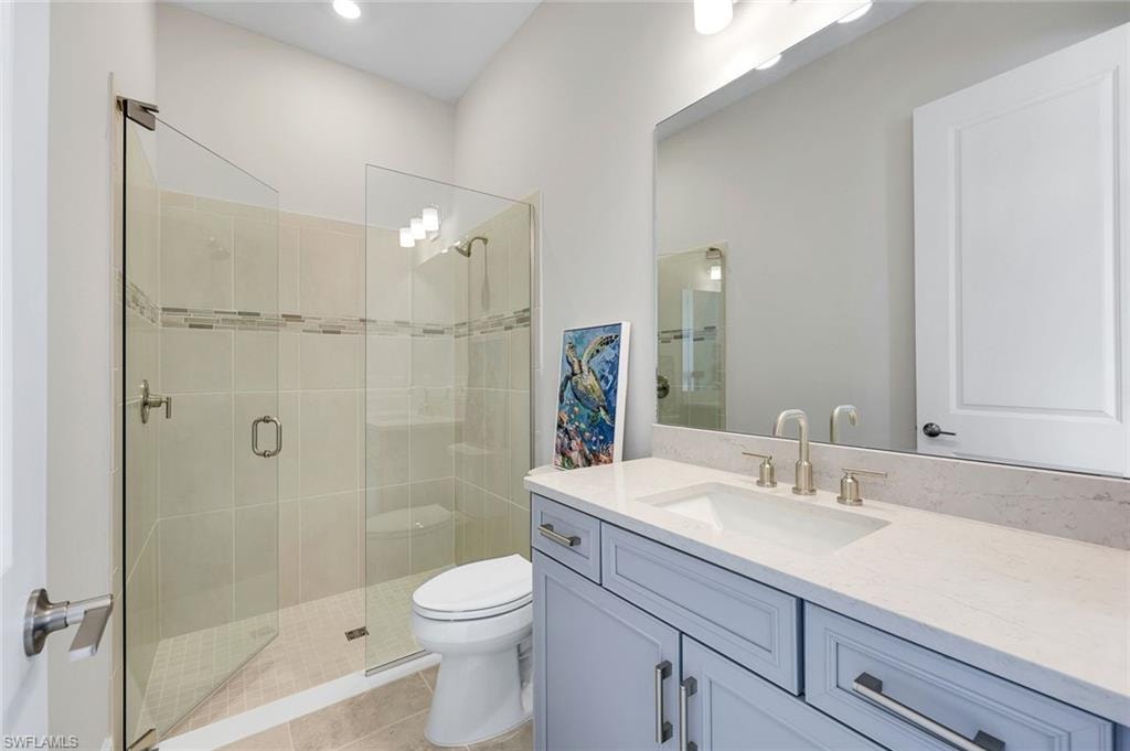 Bathroom with wallpapered walls, vanity, and shower / bathtub combination