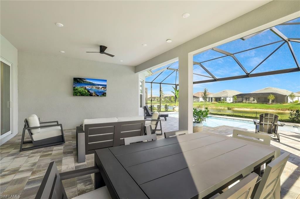 View of patio with a sunroom, a residential view, an outdoor pool, and a lanai