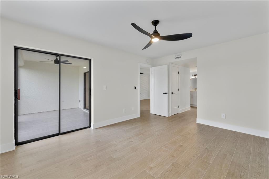 Unfurnished bedroom with a closet, light wood-style flooring, ceiling fan, and connected bathroom