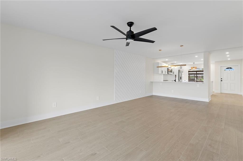 Unfurnished living room featuring light wood-type flooring, recessed lighting, and ceiling fan