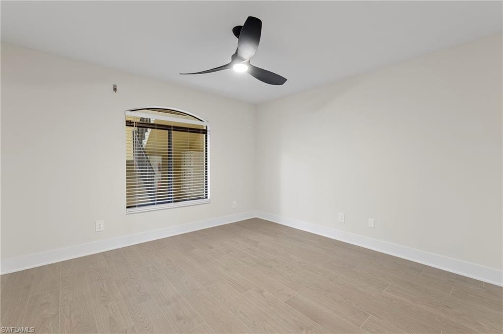 Empty room featuring light wood finished floors and ceiling fan