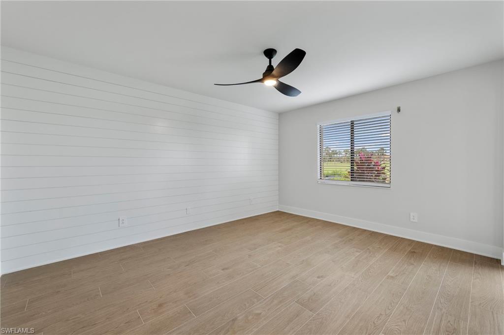 Spare room with light wood finished floors and ceiling fan