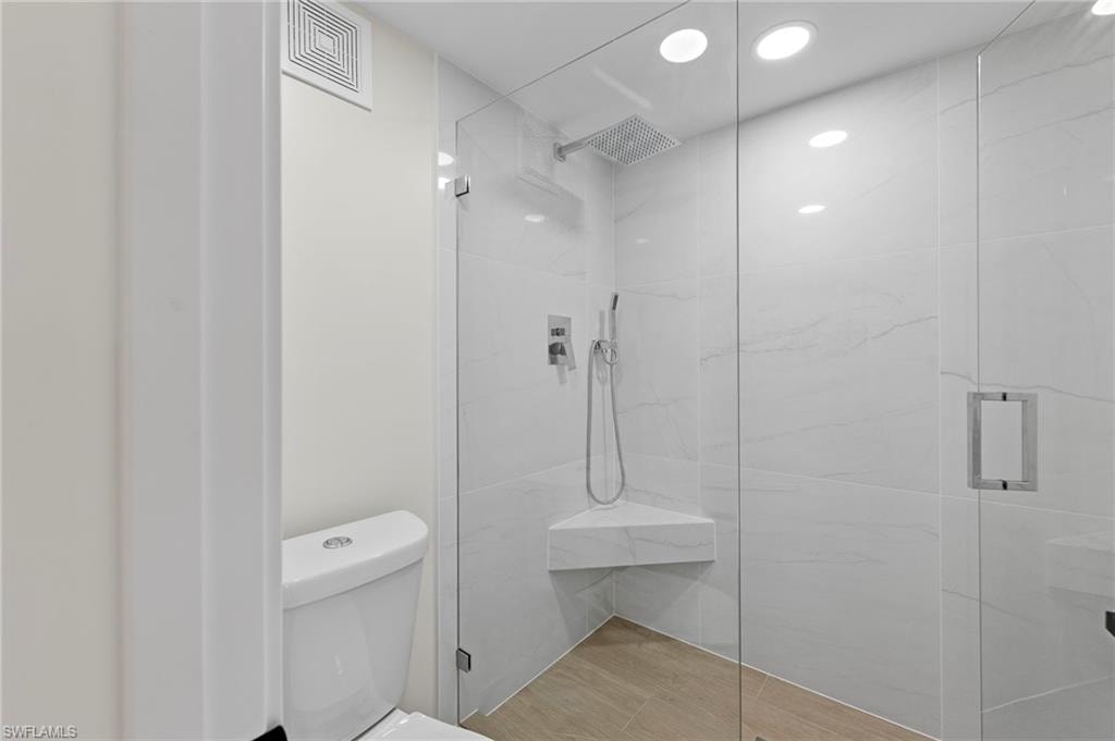 Bathroom featuring a marble finish shower and recessed lighting