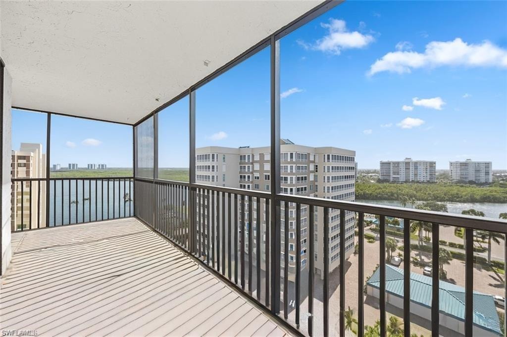 Balcony with a sunroom and a water view