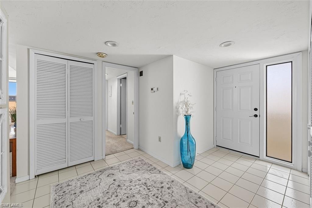 Foyer featuring baseboards and light tile patterned floors