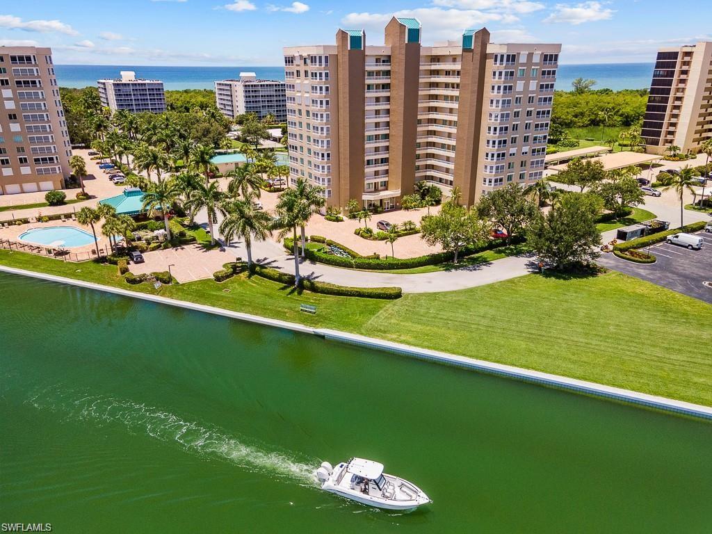 Aerial view of a large body of water and apartment complex / building
