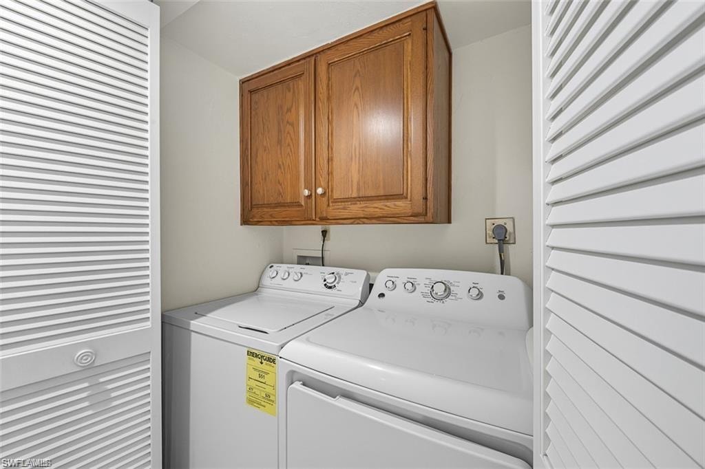 Laundry room featuring cabinet space and washing machine and dryer