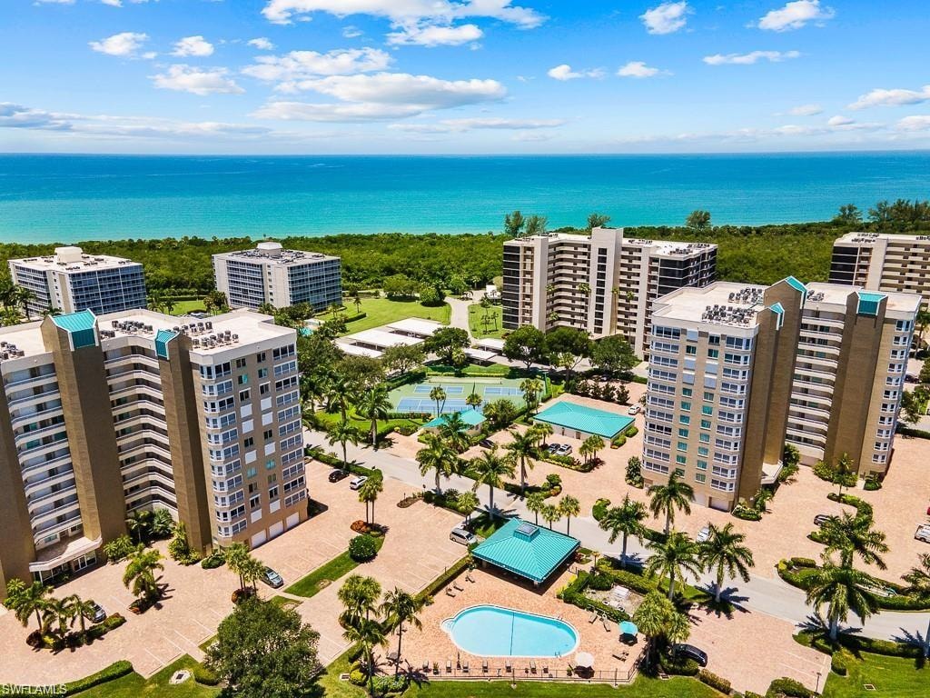 Aerial view of a pool area and a large body of water
