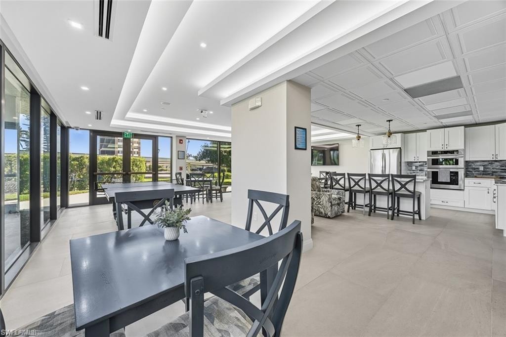 Lobby Dining room with floor to ceiling windows and a tray ceiling