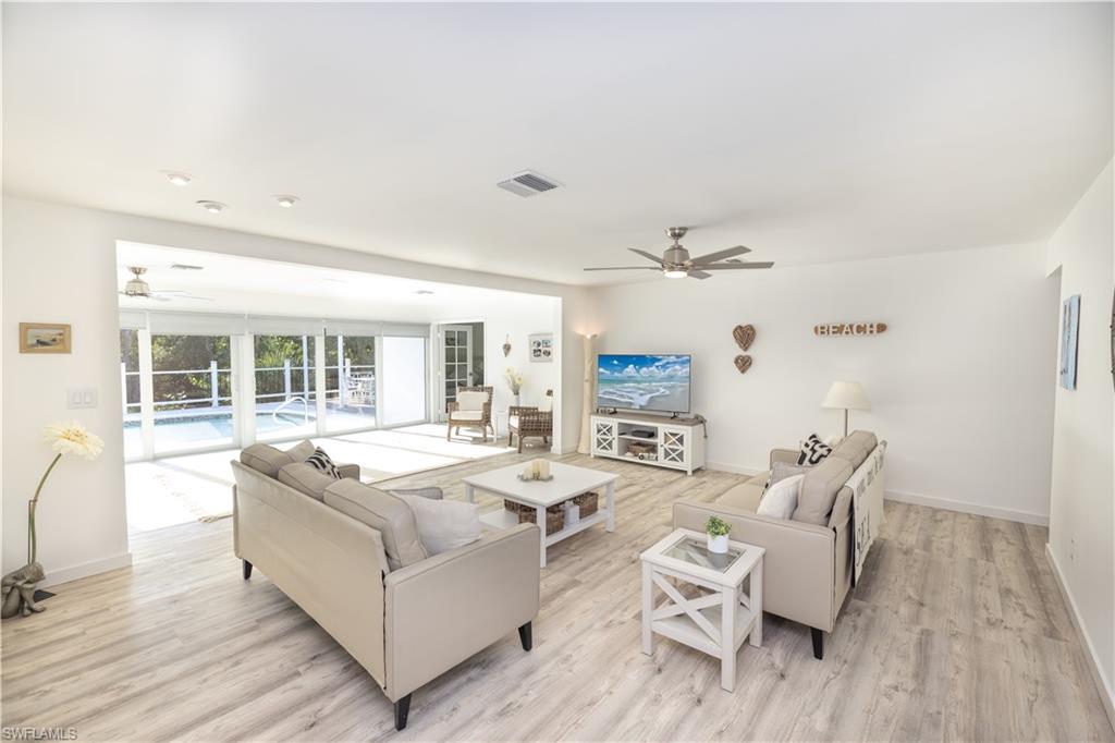 Living area featuring ceiling fan and light wood-style floors