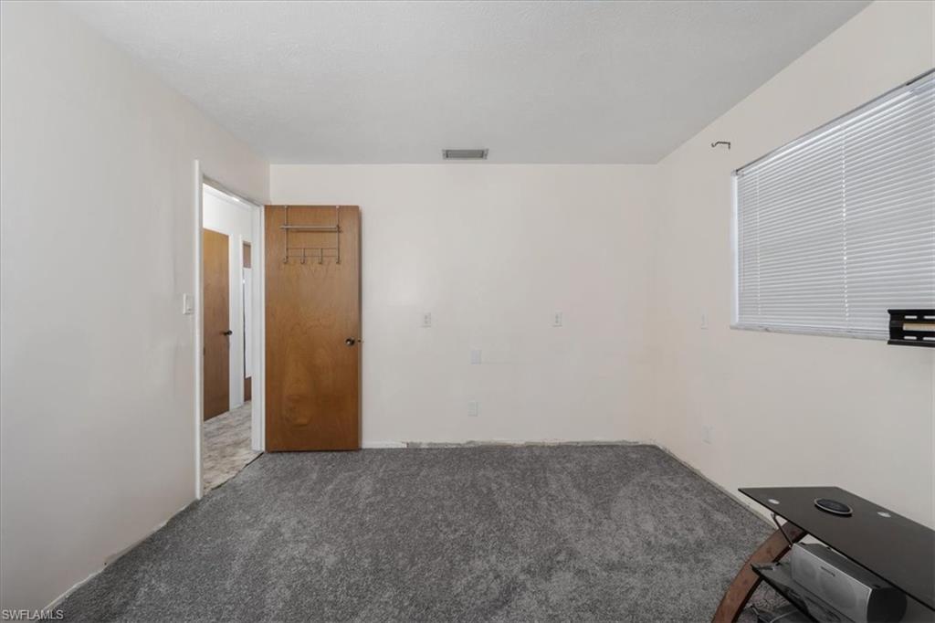 Unfurnished room with carpet floors