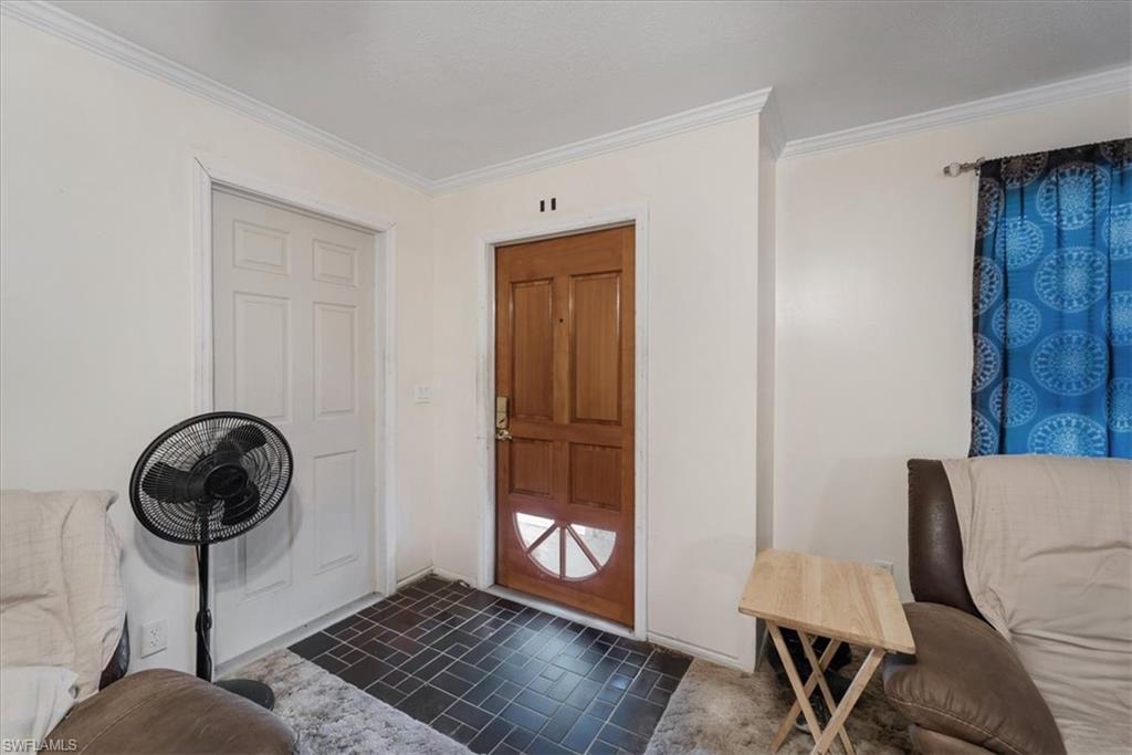 Foyer featuring ornamental molding