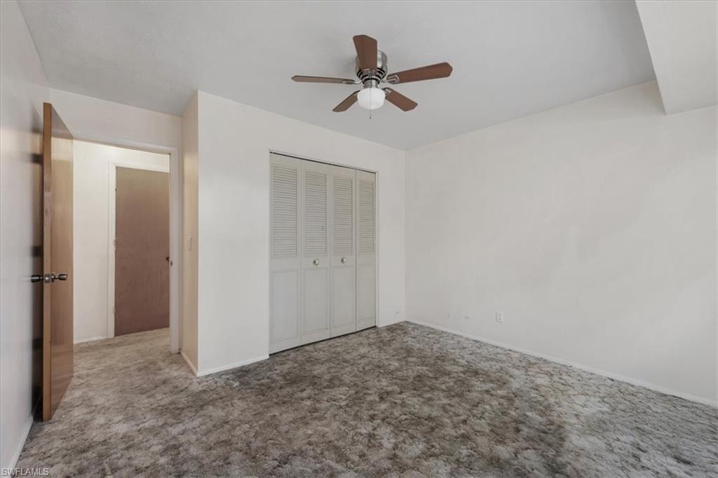 Unfurnished bedroom featuring carpet, a closet, and ceiling fan