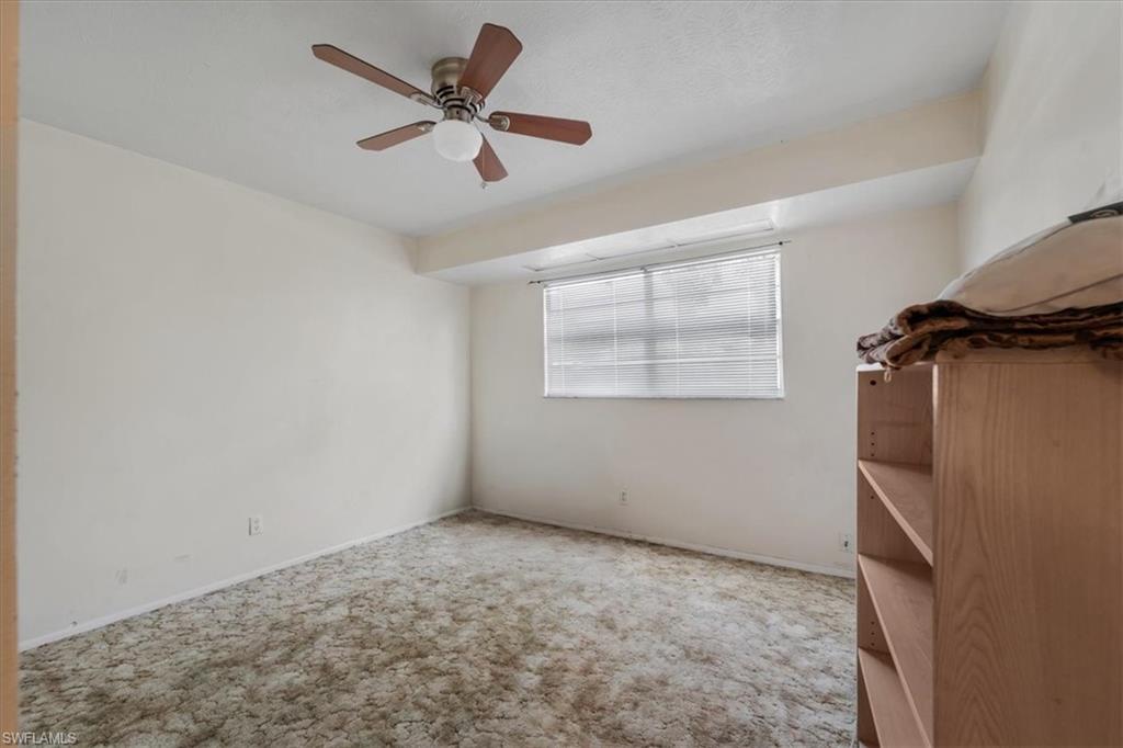 Spare room featuring ceiling fan and carpet