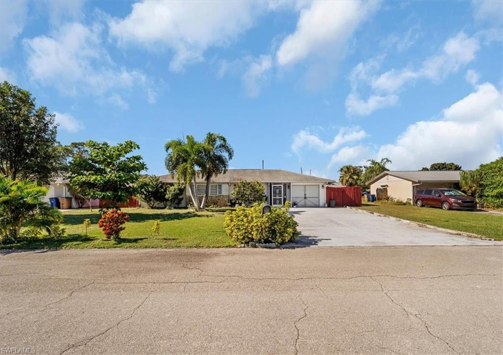 Ranch-style home with driveway and a garage
