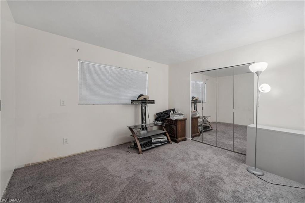 Bedroom with a closet and carpet floors