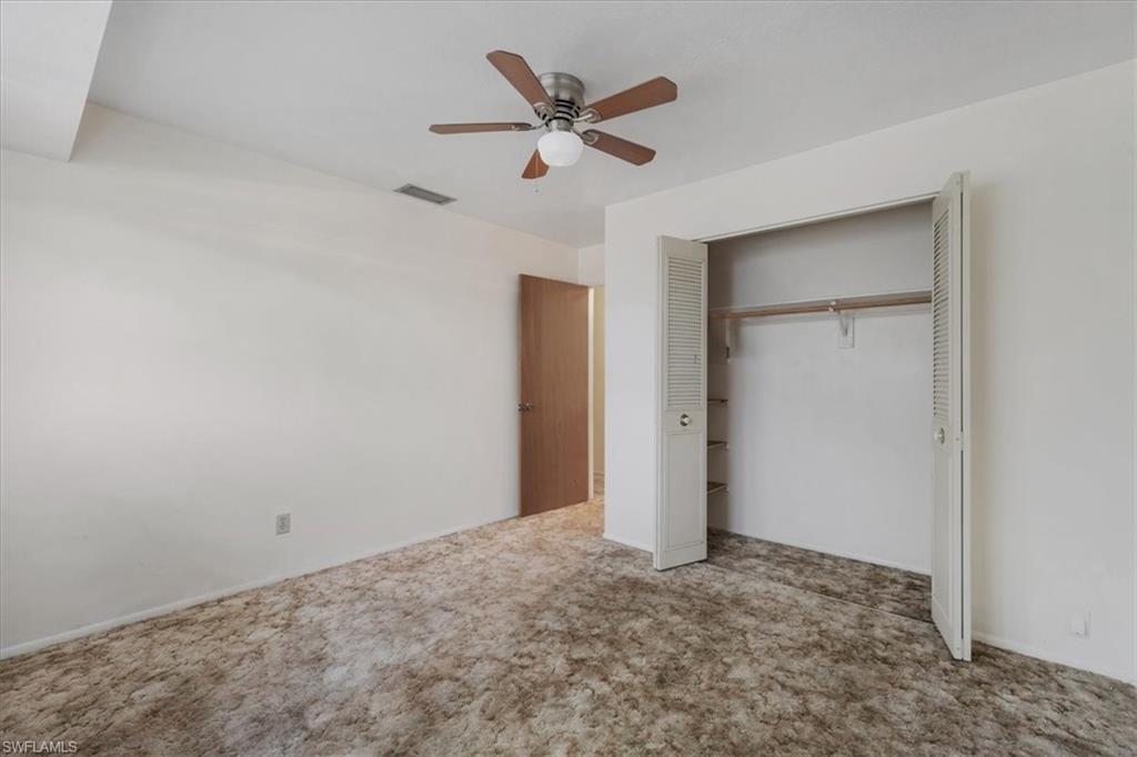 Unfurnished bedroom with a closet, a ceiling fan, and carpet floors