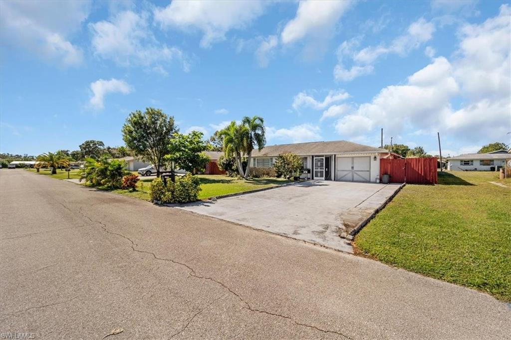 Ranch-style home featuring concrete driveway and a garage